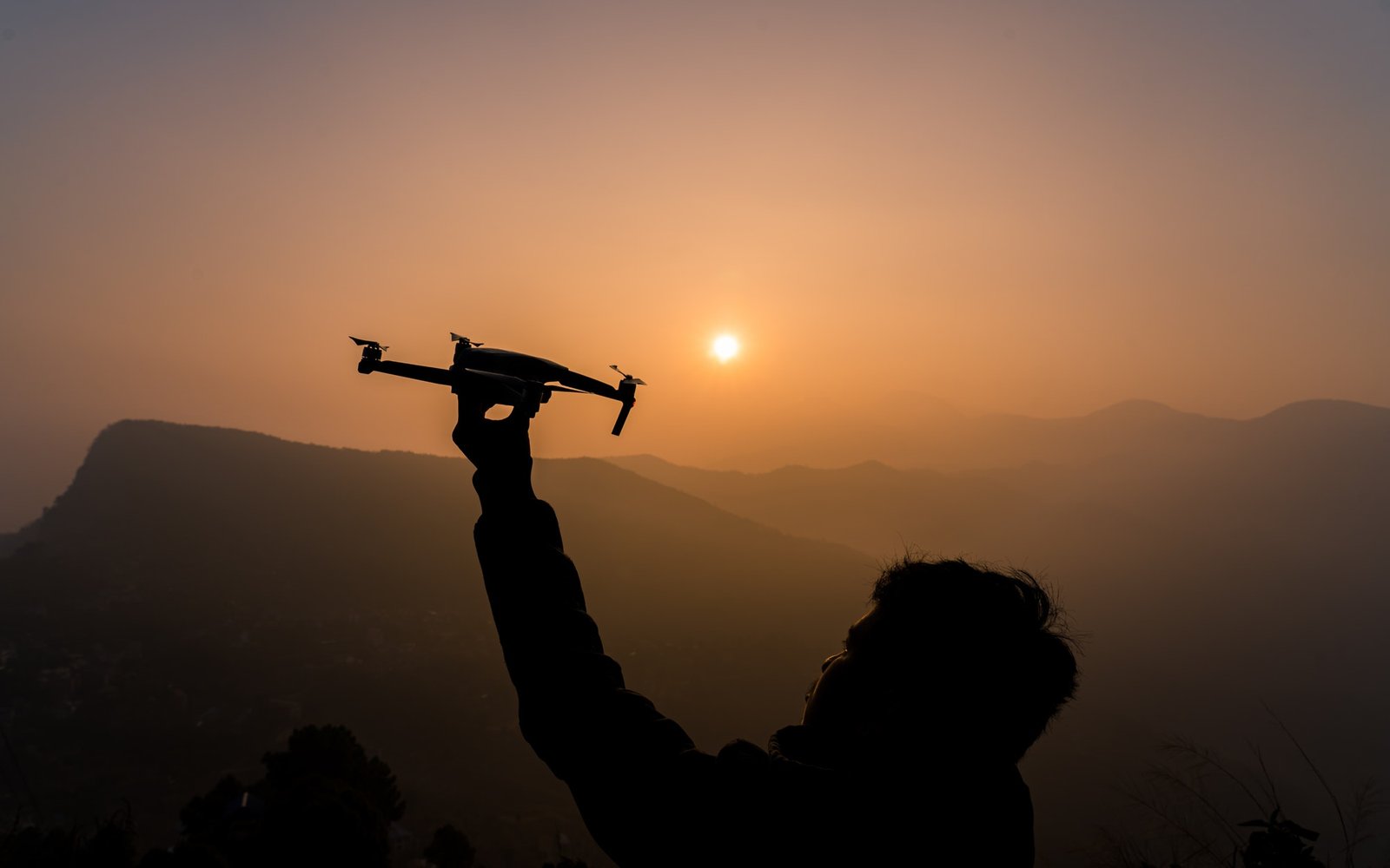 flying drone during sunrise