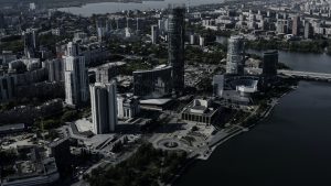 Tall buildings with blue windows taken from a drone. Stock footage. A magnificent landscape of a big